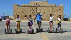 Group of segwayers on segways posing for the camera.