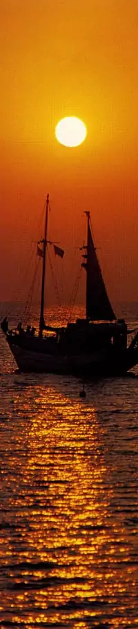 Ship sailing in the sunset image.