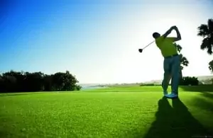 Man taking another swing shot over a golf course.
