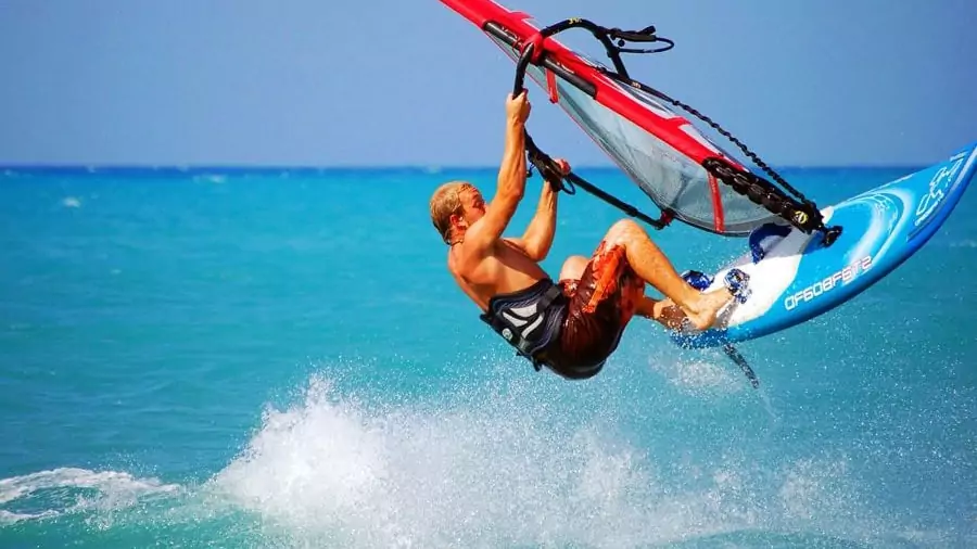 Man doing a trick-shot while kite surfing image.